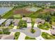 Aerial photograph displaying a home in a community adjacent to a peaceful pond at 27223 Nostalgia Dr, Leesburg, FL 34748