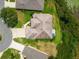Aerial view of backyard with lawn, landscaping, and view of the roof at 27223 Nostalgia Dr, Leesburg, FL 34748