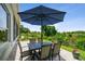 Paver patio with table, chairs, and umbrella provides a serene outdoor space at 27223 Nostalgia Dr, Leesburg, FL 34748