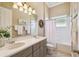 Bathroom featuring double sinks, neutral walls, and shower-tub combo at 27223 Nostalgia Dr, Leesburg, FL 34748