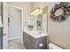 Bathroom featuring double sinks, neutral walls, and tile flooring at 27223 Nostalgia Dr, Leesburg, FL 34748