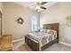 Bedroom with ceiling fan, window, hardwood furniture and colorful quilt at 27223 Nostalgia Dr, Leesburg, FL 34748