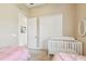 Bright bedroom with twin beds, closet, and neutral walls at 27223 Nostalgia Dr, Leesburg, FL 34748