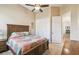 Bedroom with ceiling fan, window, hardwood furniture and colorful quilt and closet at 27223 Nostalgia Dr, Leesburg, FL 34748