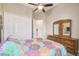 Bright bedroom featuring a ceiling fan, closet, and wood dresser at 27223 Nostalgia Dr, Leesburg, FL 34748