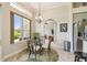 Sunny breakfast nook features a glass table with wicker chairs and a view to lush landscaping at 27223 Nostalgia Dr, Leesburg, FL 34748