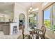 Bright breakfast nook with glass table, wicker chairs, and view to lanai and tropical landscape at 27223 Nostalgia Dr, Leesburg, FL 34748