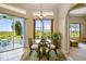 Bright dining area features a glass table, comfortable chairs, and a view of the green outdoors at 27223 Nostalgia Dr, Leesburg, FL 34748