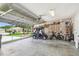Well-lit garage showcasing a golf cart, bicycle, and open garage door at 27223 Nostalgia Dr, Leesburg, FL 34748