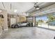 Spacious garage featuring a car and an open garage door with neighborhood view at 27223 Nostalgia Dr, Leesburg, FL 34748