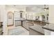 Open kitchen showcasing countertops, cabinetry, and tile flooring with view of the living spaces at 27223 Nostalgia Dr, Leesburg, FL 34748