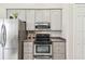 Kitchen area with stainless appliances, light cabinets, and recessed lighting at 27223 Nostalgia Dr, Leesburg, FL 34748