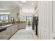 Well-lit kitchen featuring modern appliances, tile flooring, and ample counter space, ideal for culinary enthusiasts at 27223 Nostalgia Dr, Leesburg, FL 34748
