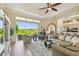 Bright living room featuring a ceiling fan and large sliding doors showcasing a serene outdoor view at 27223 Nostalgia Dr, Leesburg, FL 34748