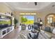 Bright living room featuring a ceiling fan and large sliding doors showcasing a serene outdoor view at 27223 Nostalgia Dr, Leesburg, FL 34748