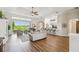 Spacious living room with hardwood floors, large windows, and an open layout, ideal for entertaining guests at 27223 Nostalgia Dr, Leesburg, FL 34748