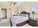 Inviting main bedroom features a king bed, neutral decor, and view of ensuite bath at 27223 Nostalgia Dr, Leesburg, FL 34748