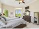 Comfortable main bedroom with king bed, dresser, and lanai access showcasing the room's layout at 27223 Nostalgia Dr, Leesburg, FL 34748