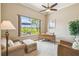 Bright office featuring a desk, seating, and a window with an umbrella-covered patio view at 27223 Nostalgia Dr, Leesburg, FL 34748