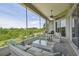 Comfortable screened porch with seating, a ceiling fan, and a view at 27223 Nostalgia Dr, Leesburg, FL 34748