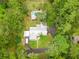 Aerial view of the house nestled among lush greenery, showcasing the in-ground pool at 3341 Se 45Th St, Ocala, FL 34480
