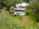 Aerial view of a pool area, featuring a covered deck, palm trees, and verdant lawn, offering a private outdoor retreat at 3341 Se 45Th St, Ocala, FL 34480