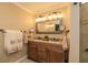 Bathroom featuring double sink vanity with granite countertop and decorative mirror at 3341 Se 45Th St, Ocala, FL 34480