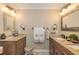 Bright bathroom featuring double sinks with granite countertops and decorative mirrors at 3341 Se 45Th St, Ocala, FL 34480