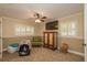 Bedroom with ceiling fan, plantation shutters, built-in storage, and carpet flooring at 3341 Se 45Th St, Ocala, FL 34480