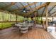 Expansive covered patio with a bar and plenty of seating for entertaining guests at 3341 Se 45Th St, Ocala, FL 34480