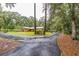 Exterior home view with long driveway, showcasing lush landscaping and ample parking space at 3341 Se 45Th St, Ocala, FL 34480