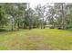 Expansive lawn with mature trees, offering privacy and a park-like setting for the home at 3341 Se 45Th St, Ocala, FL 34480