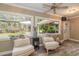 Cozy sunroom with large windows offering a view of the lush backyard at 3341 Se 45Th St, Ocala, FL 34480