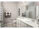 Bright bathroom featuring a double vanity, neutral paint, and gray and white decor at 1278 Whispering Ln, Minneola, FL 34715