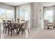 Dining area with a wooden table, comfortable seating, and a sliding glass door offering outdoor views at 1278 Whispering Ln, Minneola, FL 34715