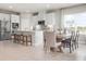 Modern kitchen with stainless steel appliances, white cabinetry, tile backsplash, and an adjacent dining area at 1278 Whispering Ln, Minneola, FL 34715