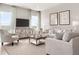 Inviting living room featuring large windows, comfortable sofas, and stylish decor for relaxing and entertaining at 1278 Whispering Ln, Minneola, FL 34715
