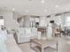 Open-concept living room showcasing a modern kitchen, dining area, and comfortable seating arrangement at 1278 Whispering Ln, Minneola, FL 34715