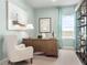 Well-lit home office with a large wooden desk, comfortable armchair, and natural light from the window at 1278 Whispering Ln, Minneola, FL 34715