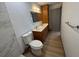Bathroom with a double sink vanity and updated fixtures next to the toilet and the walk-in shower at 2963 Poplar Ave, Leesburg, FL 34748