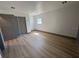 Spacious bedroom with hardwood floors, closet, and a large window for natural light at 2963 Poplar Ave, Leesburg, FL 34748