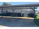 Exterior view featuring carport parking in front of the home with a glimpse of the enclosed lanai at 2963 Poplar Ave, Leesburg, FL 34748
