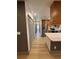 Hallway view showcasing the kitchen, grey doors and light colored flooring at 2963 Poplar Ave, Leesburg, FL 34748