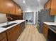 Modern kitchen with stainless steel appliances, quartz counters, and in-unit washer and dryer hookups at 2963 Poplar Ave, Leesburg, FL 34748