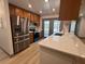 Modern kitchen with stainless steel appliances, quartz countertops, and custom cabinetry at 2963 Poplar Ave, Leesburg, FL 34748