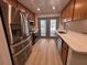 Contemporary kitchen featuring stainless steel appliances, wood cabinets, and quartz countertops at 2963 Poplar Ave, Leesburg, FL 34748