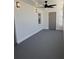 Lanai with freshly painted gray concrete floors and new ceiling fan, offering a cool, relaxing retreat at 2963 Poplar Ave, Leesburg, FL 34748