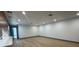 Spacious living room with wood-look floors, recessed lighting and an open floorplan at 2963 Poplar Ave, Leesburg, FL 34748