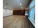 Bright living room with wood-look floors, designer accent wall and recessed lighting at 2963 Poplar Ave, Leesburg, FL 34748