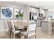 Comfortable dining area, adjacent to the kitchen, has seating for six and modern botanical art at 1203 Turtle Island Rd, Lady Lake, FL 32159